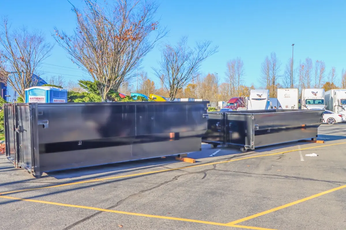Professional dumpster rental service with roll-off container on residential driveway in McGregor